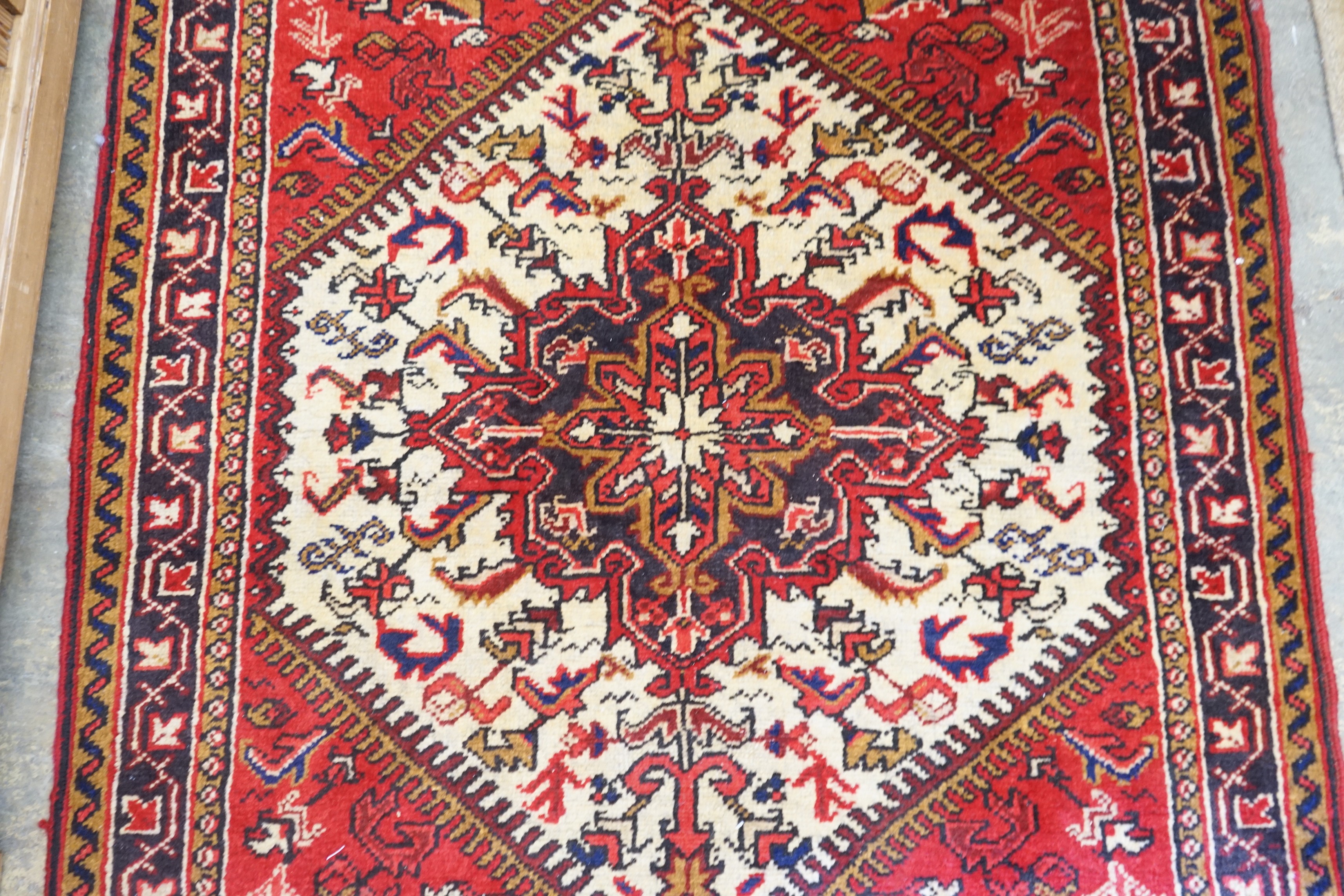 A Heriz ivory ground rug, 148 x 110cm